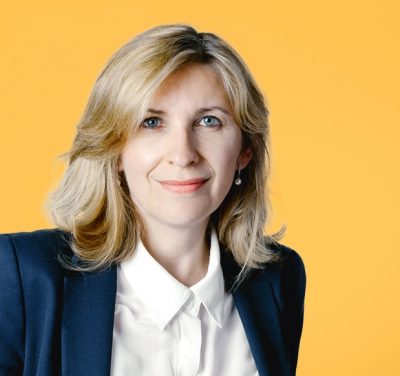 photographe portrait corporate a aix en provence marseille pertuis région sud photographie-portrait-corporate-a-aix-en-provence-marseille-femme-veste-sombre-chemisier-blanc-bouton-sur-fond-jaune